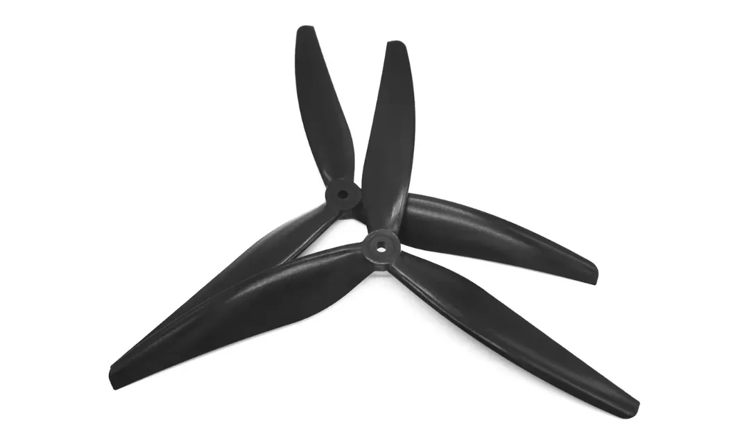 Close-up of a three-blade propeller designed for drones, showcasing its shape and material.
